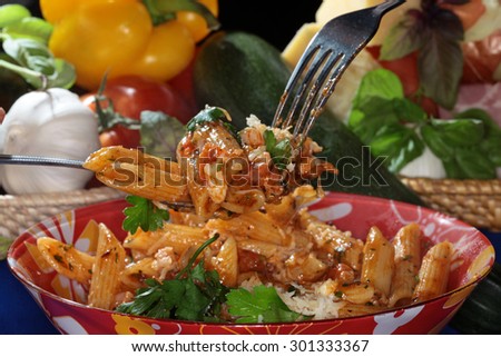 macro appetizing Feathers Pasta with cheese and sauce on dark background studio