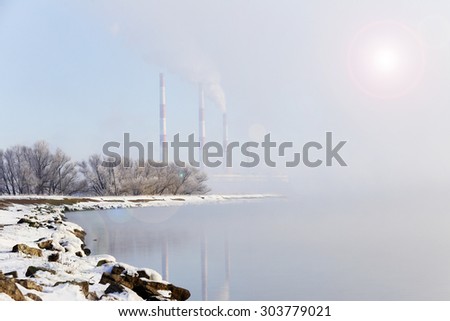 winter landscape Hydroelectric in dense fog early in the morning at sunrise