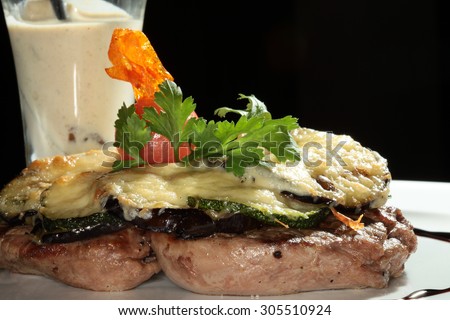 macro steak with baked vegetables and white sauce