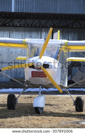 close-up of a small plane near hangar early spring