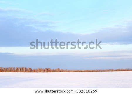 winter landscape colorful sunrise over the snow-covered field