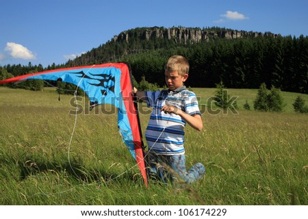 Teenage, Caucasian boy made kite on a mountain meadow - Table Mountains in Poland in village Pasterka