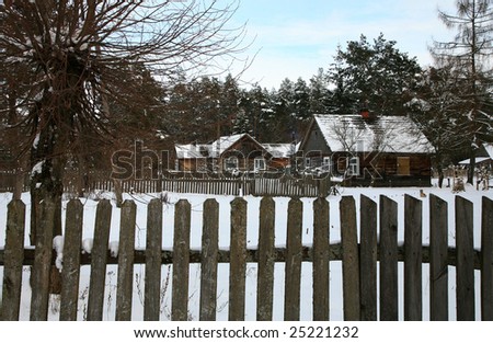 Small old village in west Poland, Koterka, wooden cottage by winter. Seasonal scenery. Farm in the snow.