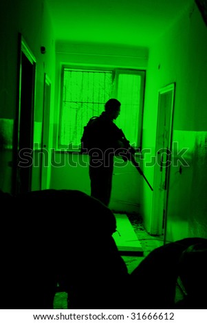 POLAND - MARCH 28 : View through the night vision device during a soldiers training (battle camp) to conduct an attack inside a building at night March 28, 2008 in Poland.