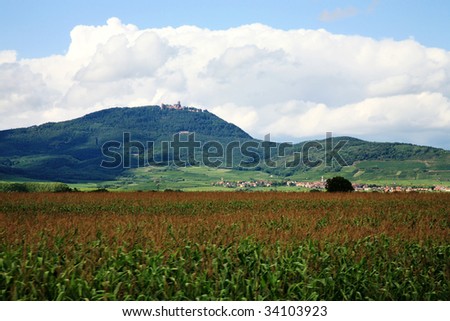 Alsace wine route. Vosges Mountain range with the clouds - view on castle Haut-Koenigsbourg, France.