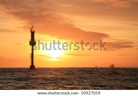 Sunset to the sea North. Ships container ships relating to the sky with the skyline.