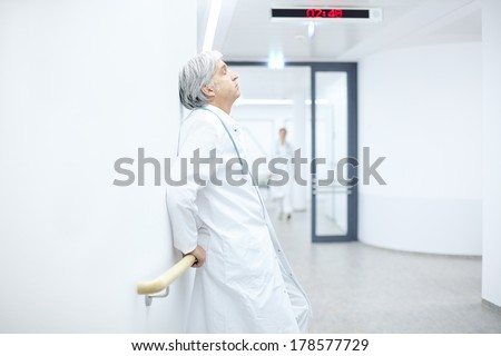 leaning against the wall in the hospital sleeping doctor
