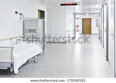 Corridor with white bed in the hospital with trolley