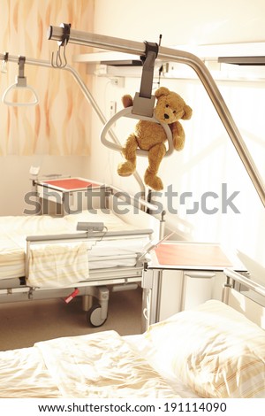 Hospital bed with teddy bear and gallows