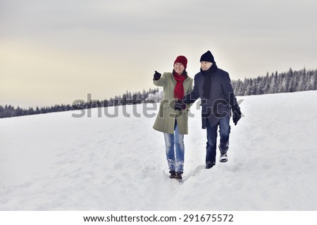 Couple running in the snow and seen the area
