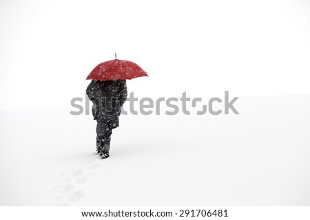 Man walking in winter snow storm in the snow on mountain top