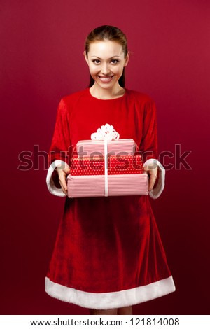 Attractive Asian Mixed Female in Christmas Outfit holding boxes of gifts