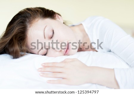 Attractive Asian Mixed Woman in Bed sleeping holding pillow