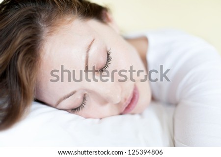 Attractive Asian Mixed Woman in Bed sleeping on pillow