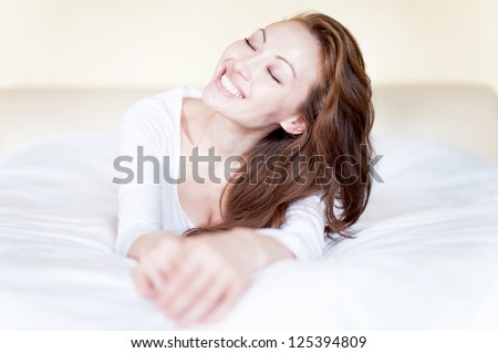 Attractive Asian Mixed Woman happily smiling in bed