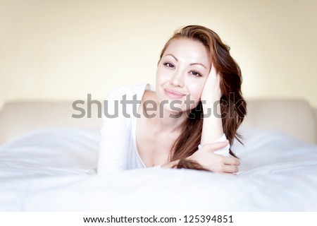 Attractive Asian Mixed Woman resting on the bed