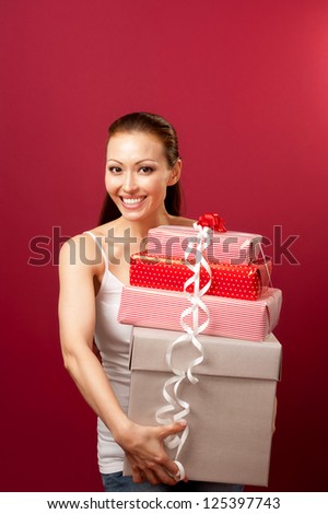 Attractive Asian Mixed Woman holding many boxes with a smile