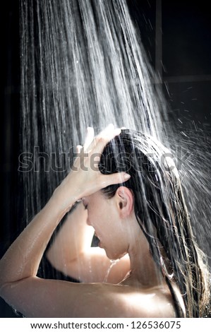 Attractive Mixed Female washing her hair in shower
