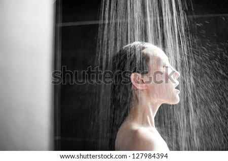 Attractive Mixed Asian Female enjoying a shower directly under the water