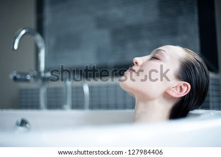 Attractive Mixed Asian Female enjoying bath