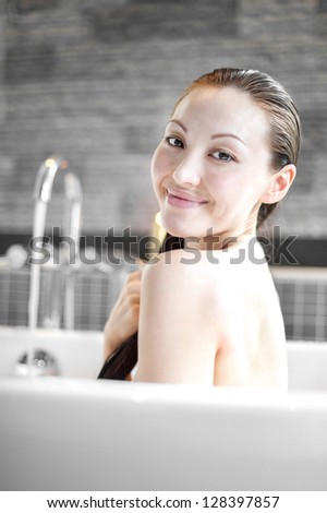 Attractive mixed asian woman smiling in bath