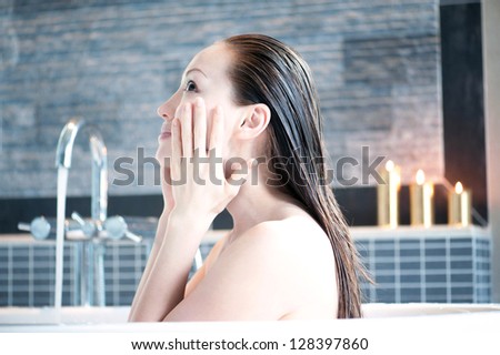 Attractive mixed asian washing face in tub