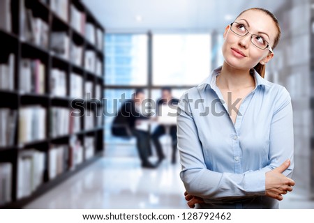 Attractive Mixed Business Woman thinking with business background