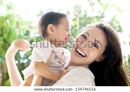 Attractive Mixed Female Lifestyle Spending Time With Child Laughing