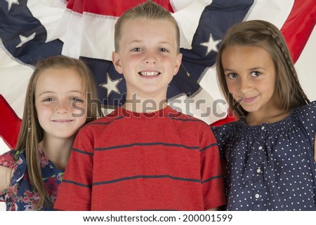 Patriotic children in front of flag banner