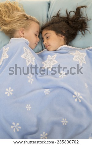 Young girls in bed asleep snowflake blanket