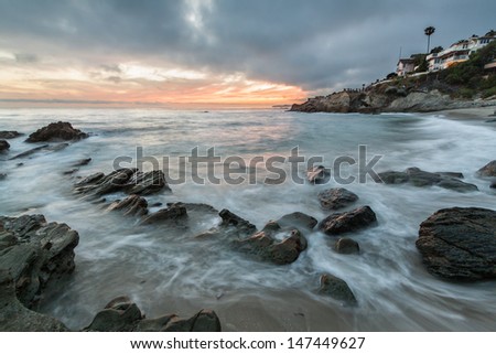 Rocky coastal beach seascape with dramatic red sky. This is an image of a rocky coastal beach scene taken at just after sunset with a dramatic red sky.  Photo was taken in Laguna Beach, California.