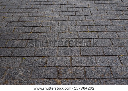 cobblestone sidewalk background. Grey stone texture