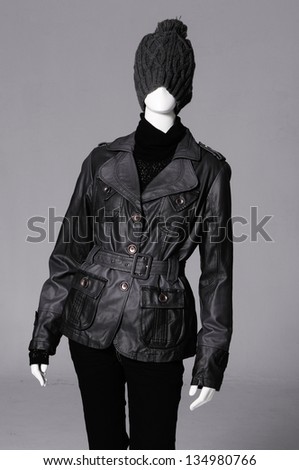 female black clothing in hat on mannequin-gray background