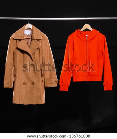 Red jacket and coat hanging on hanger