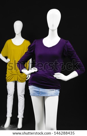 two mannequin dressed in blouse with shirt on black background