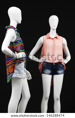 Two mannequin dressed in shirt and short trousers