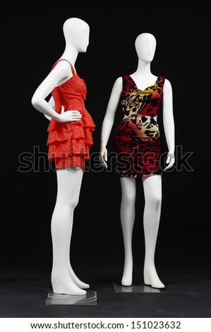 Two mannequin female in sundress evening gown clothes on black background