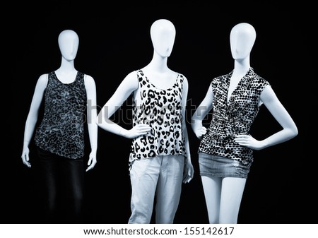 black and white mannequin dressed in shirt and trousers-black background