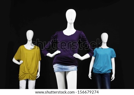 Three mannequin female dress and isolated on black background