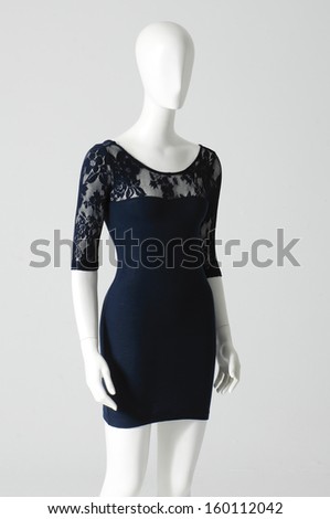 Black evening gown on mannequin on gray background