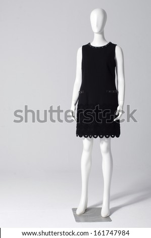 full length black dress mannequin isolated on gray background