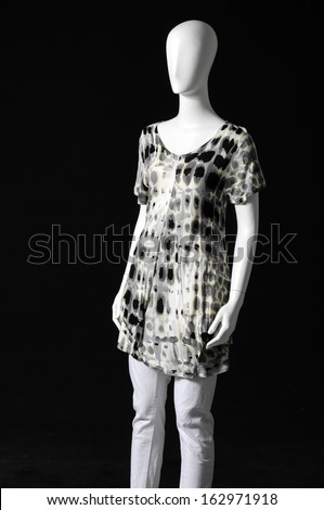 Mannequin female dressed in trousers on black background