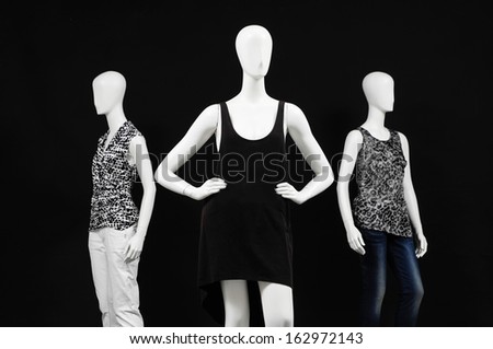 Three mannequin in dressed fashionably and isolated on black
