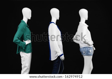 Side view three mannequin female dressed in fashion shirt and trousers ,jeans on black background