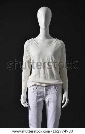 mannequin female dressed in shirt and white trousers