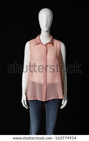 mannequin female dressed in shirt and jeans on black background