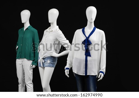 Three mannequin female dressed in fashion shirt and trousers ,jeans on black background