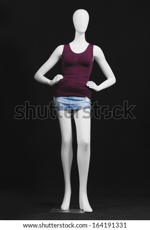 full-length female mannequin in shirt and white shorts Ã¢Â?Â?black background