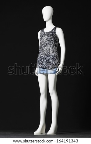 full-length mannequin in elegant shirt and jeans shorts-black background