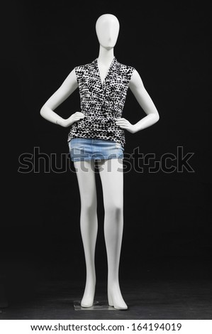 mannequin female dressed in shirt and shorts on black background